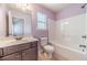 Clean bathroom featuring a vanity, toilet, and shower-tub combination at 1022 Nestling Dr, Lawrenceville, GA 30045