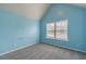 Cozy bedroom featuring carpeted floors, natural light from the window, and light blue walls at 1022 Nestling Dr, Lawrenceville, GA 30045