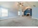 Large bonus room with a fireplace, neutral carpet, and multiple windows letting in natural light at 1022 Nestling Dr, Lawrenceville, GA 30045
