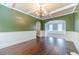 A dining room featuring dark hardwood floors, decorative molding, and a coffered ceiling at 1022 Nestling Dr, Lawrenceville, GA 30045