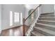 Bright foyer with hardwood floors, staircase, and decorative front door with side windows at 1022 Nestling Dr, Lawrenceville, GA 30045