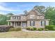 Charming two-story brick home with a welcoming front porch and well-manicured landscaping at 1022 Nestling Dr, Lawrenceville, GA 30045