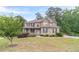 Charming two-story brick home with a well-manicured lawn, and a welcoming light blue front door at 1022 Nestling Dr, Lawrenceville, GA 30045