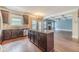 Open kitchen with island, stainless appliances, dark wood cabinets and hardwood floors at 1022 Nestling Dr, Lawrenceville, GA 30045