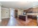 Open-concept kitchen with a granite island, stainless steel appliances, and dark wood cabinetry at 1022 Nestling Dr, Lawrenceville, GA 30045
