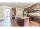 Spacious kitchen featuring a central island, stainless steel appliances, and dark wood cabinetry at 1022 Nestling Dr, Lawrenceville, GA 30045