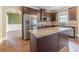 Well-equipped kitchen with an island, stainless steel refrigerator, and dark wood cabinetry at 1022 Nestling Dr, Lawrenceville, GA 30045
