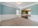 An open-concept living room with carpet, white base trim and wall molding, and archways at 1022 Nestling Dr, Lawrenceville, GA 30045
