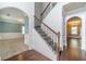 Elegant foyer with a staircase featuring decorative wrought iron railings and access to formal living areas at 1022 Nestling Dr, Lawrenceville, GA 30045