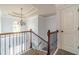 Bright staircase with decorative iron railing and chandelier, adding elegance to the home's interior at 1022 Nestling Dr, Lawrenceville, GA 30045