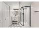 Modern bathroom features hexagon tile floor, updated vanity, and glass shower with marble surround at 2552 Hunton Ne Ct, Marietta, GA 30068