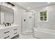 Modern bathroom features marble tile, glass shower, and white vanity with black fixtures at 2552 Hunton Ne Ct, Marietta, GA 30068