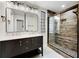 Modern bathroom featuring a double vanity, and a walk-in shower with glass door and decorative stone at 2552 Hunton Ne Ct, Marietta, GA 30068