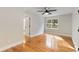 Bright bedroom with hardwood floors, ceiling fan, and natural light from the large window at 2552 Hunton Ne Ct, Marietta, GA 30068