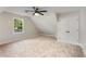 Upstairs bedroom featuring large window, ceiling fan and double door closet at 2552 Hunton Ne Ct, Marietta, GA 30068