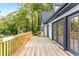 Spacious wooden deck featuring French doors and a charming railing, perfect for outdoor gatherings and relaxation at 2552 Hunton Ne Ct, Marietta, GA 30068
