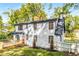 Rear exterior of updated two-story home with deck, landscaping, and fenced yard at 2552 Hunton Ne Ct, Marietta, GA 30068