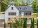 Charming two-story home with a bright blue door and a spacious wooden deck, nestled in a lush green landscape at 2552 Hunton Ne Ct, Marietta, GA 30068