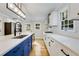 Modern kitchen featuring stainless steel appliances, white cabinets, blue island, and stylish pendant lighting at 2552 Hunton Ne Ct, Marietta, GA 30068