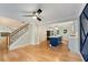 Open-concept kitchen with an island, white cabinets, stainless steel appliances, and an adjacent staircase at 2552 Hunton Ne Ct, Marietta, GA 30068