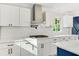 Bright kitchen showcases white cabinets, stainless steel appliances, and sleek countertops, with a stylish backsplash at 2552 Hunton Ne Ct, Marietta, GA 30068
