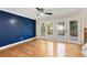 Inviting living room with hardwood floors, modern accent wall, and natural light through large glass doors at 2552 Hunton Ne Ct, Marietta, GA 30068