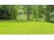 The backyard has lush green grass leading to a lake view with a private dock at 4221 Riverlake Way, Snellville, GA 30039