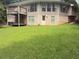 Backyard exterior featuring a door to the outside and lush green grass at 4221 Riverlake Way, Snellville, GA 30039