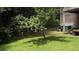 Scenic backyard with mature trees providing shade, and a glimpse of the house at 4221 Riverlake Way, Snellville, GA 30039