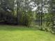 Scenic backyard with lush greenery and a serene lake view creates a peaceful outdoor space at 4221 Riverlake Way, Snellville, GA 30039