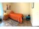 Comfortable bedroom with tiled flooring, a cheerful orange blanket and a bedside table at 4221 Riverlake Way, Snellville, GA 30039