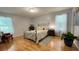 Charming bedroom features hardwood floors, soft natural light, and a metal bed frame at 4221 Riverlake Way, Snellville, GA 30039