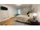 Bedroom features hardwood flooring, neutral walls, and a comfortable bed at 4221 Riverlake Way, Snellville, GA 30039