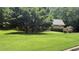Charming single-story home with lush green lawn and mature trees providing ample shade at 4221 Riverlake Way, Snellville, GA 30039