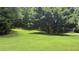Suburban single-Gathering home with mature landscaping and a spacious green lawn at 4221 Riverlake Way, Snellville, GA 30039