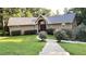 Charming single-Gathering home featuring a landscaped lawn, inviting walkway, and a stucco exterior at 4221 Riverlake Way, Snellville, GA 30039