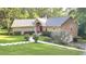 Charming single-Gathering home featuring a landscaped lawn, inviting walkway, and an attached two-car garage at 4221 Riverlake Way, Snellville, GA 30039