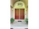 Inviting home entrance featuring a decorative storm door, tiled front porch, and sidelights at 4221 Riverlake Way, Snellville, GA 30039