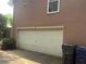 Two car garage exterior with trashcans for convenient disposal at 4221 Riverlake Way, Snellville, GA 30039