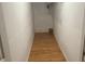 Narrow hallway with clean white walls and wooden flooring at 4221 Riverlake Way, Snellville, GA 30039