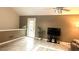 Living room features tile flooring, a neutral palette, and door to the outdoors at 4221 Riverlake Way, Snellville, GA 30039