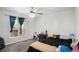 Bedroom featuring a ceiling fan, hardwood floors, and a large window at 225 Hardwood Dr, Covington, GA 30016