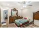 Bedroom featuring hardwood floors, ceiling fan, a window view, and traditional furniture at 225 Hardwood Dr, Covington, GA 30016