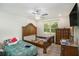 Bright bedroom featuring hardwood floors, ceiling fan, and traditional-style furniture at 225 Hardwood Dr, Covington, GA 30016