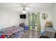 Bedroom with a ceiling fan, hardwood floors, a window view, and tv at 225 Hardwood Dr, Covington, GA 30016