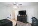 Bedroom featuring hardwood floors, a ceiling fan, and large windows at 225 Hardwood Dr, Covington, GA 30016