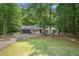 A charming single-Gathering home featuring a well-manicured lawn, mature trees, and a classic two-car attached garage at 225 Hardwood Dr, Covington, GA 30016
