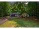 A charming single-Gathering home featuring a well-manicured lawn, mature trees, and a classic two-car attached garage at 225 Hardwood Dr, Covington, GA 30016
