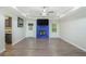 Bright living room featuring a blue brick fireplace, modern ceiling fan, and gray wood flooring at 225 Hardwood Dr, Covington, GA 30016