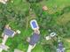 Aerial view of a property showcasing a large in-ground pool, landscaped backyard, and surrounding mature trees at 232 Christian Cir, Carrollton, GA 30116